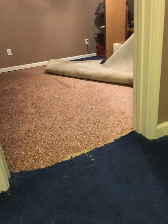 Carpet pad removal revealing water damage during Water Mitigation Services in Hope Mills